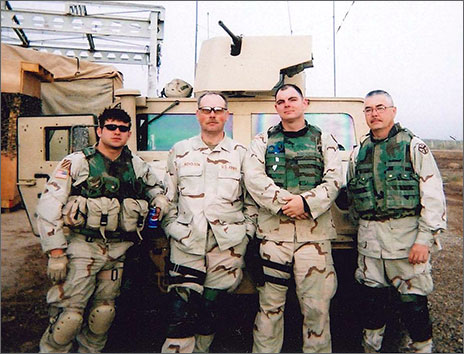 Joey Hunt in military uniform standing beside other soldiers in uniform